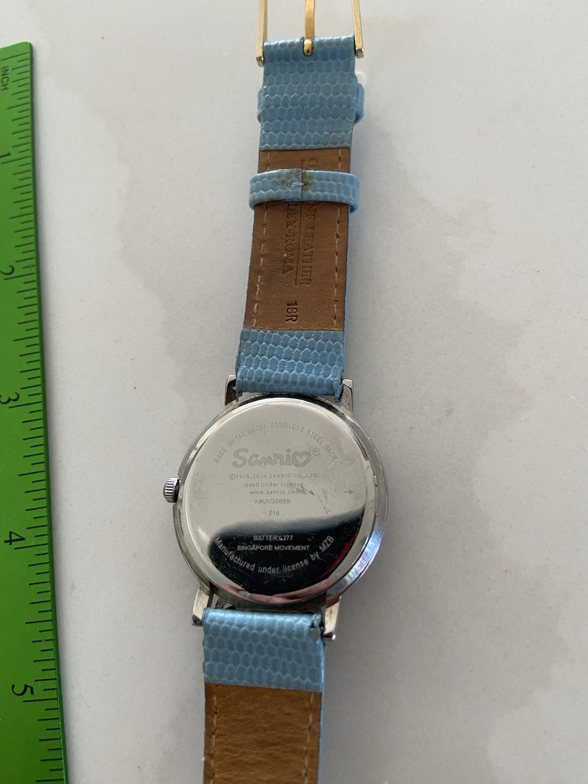 Hello Kitty watch with a light blue faux leather strap and rhinestone bezel Runs