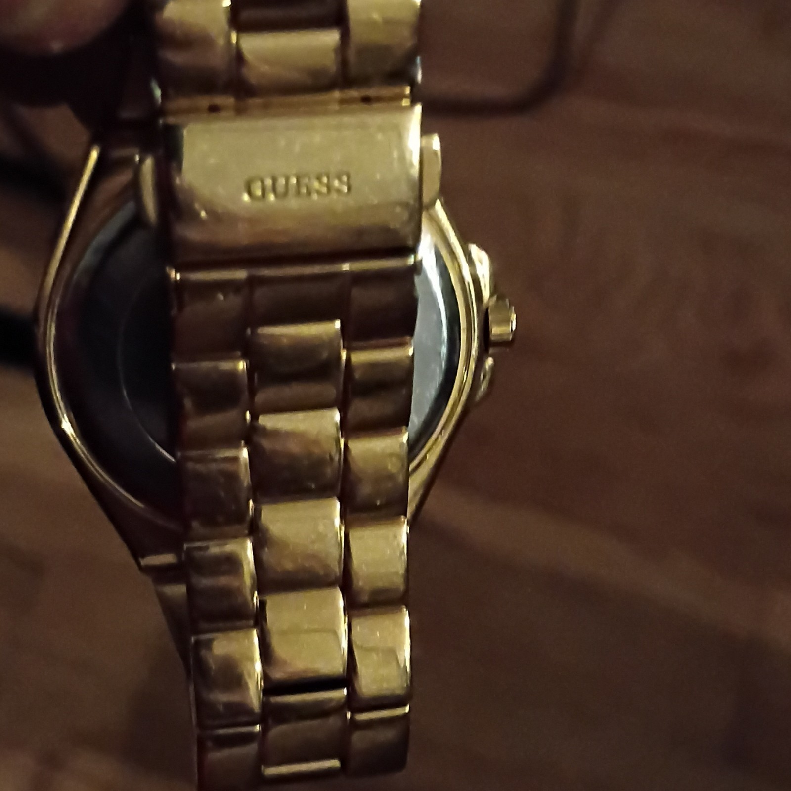 GUESS Women’s Gold Tone Analog Dress Watch White Dial Roman/Gem Bezel Date