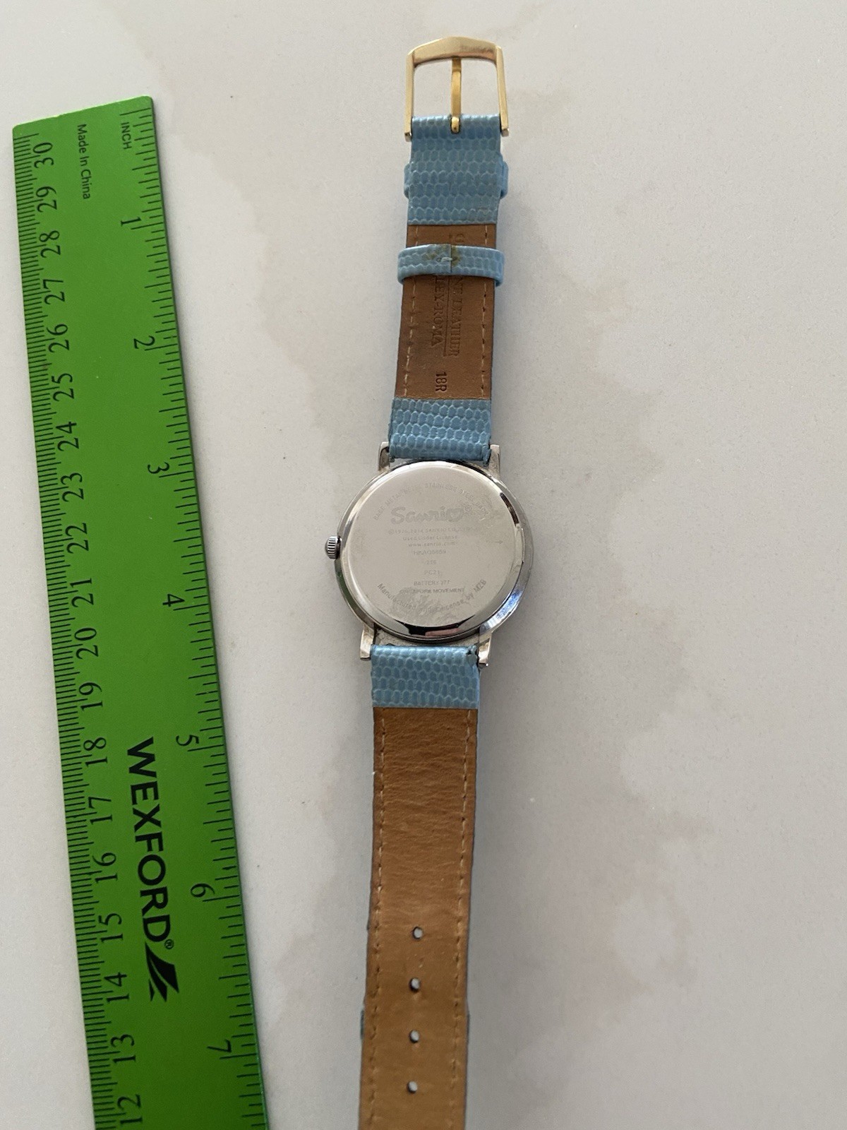 Hello Kitty watch with a light blue faux leather strap and rhinestone bezel Runs