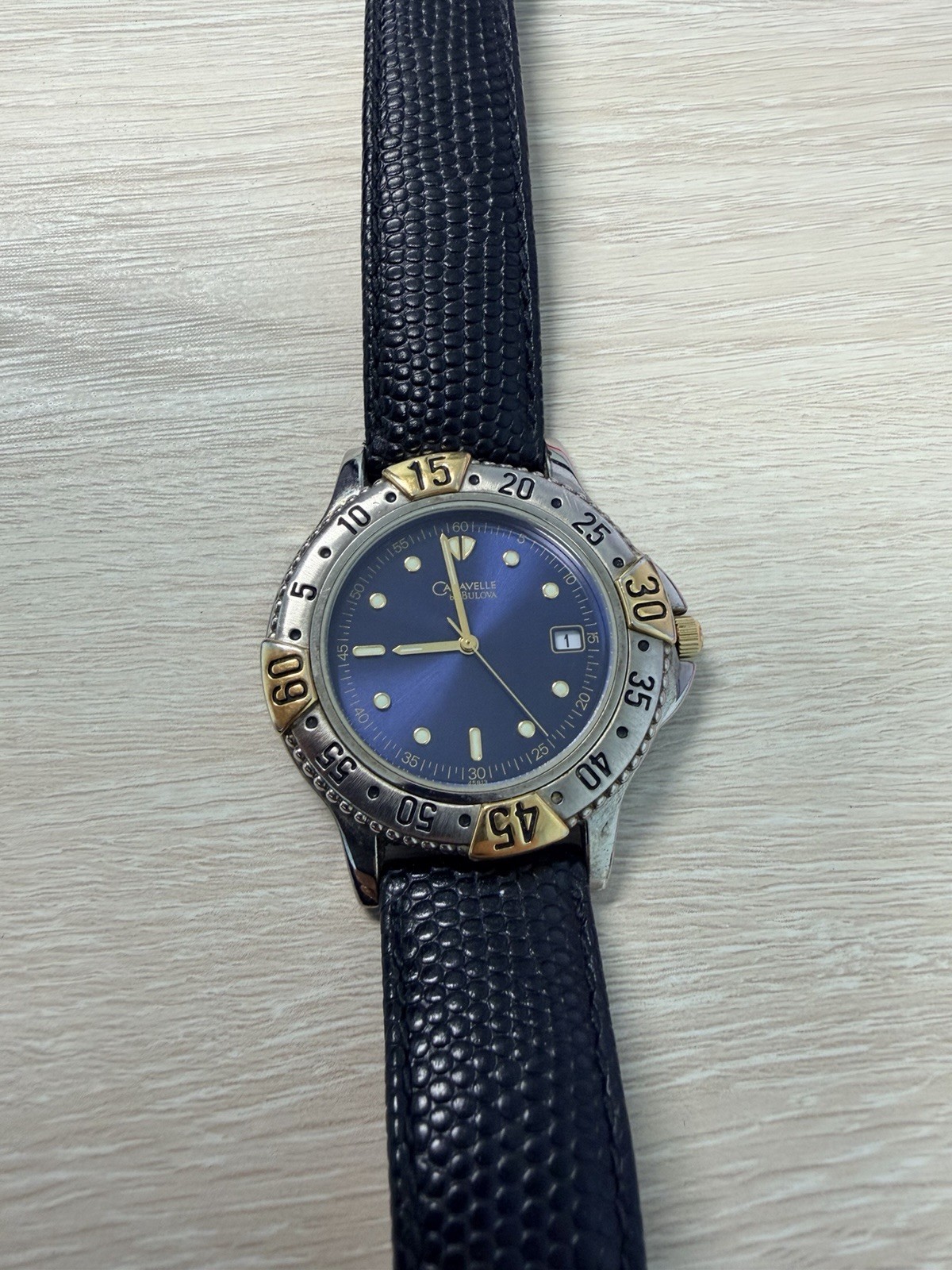 Bulova Caravelle Quartz Blue Dial Date Two-Tone Rotating Bezel 26mm Leather