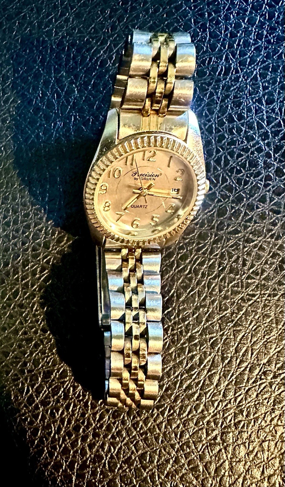 vintage Precision by Gruen quartz watch featuring a two-tone gold and silve