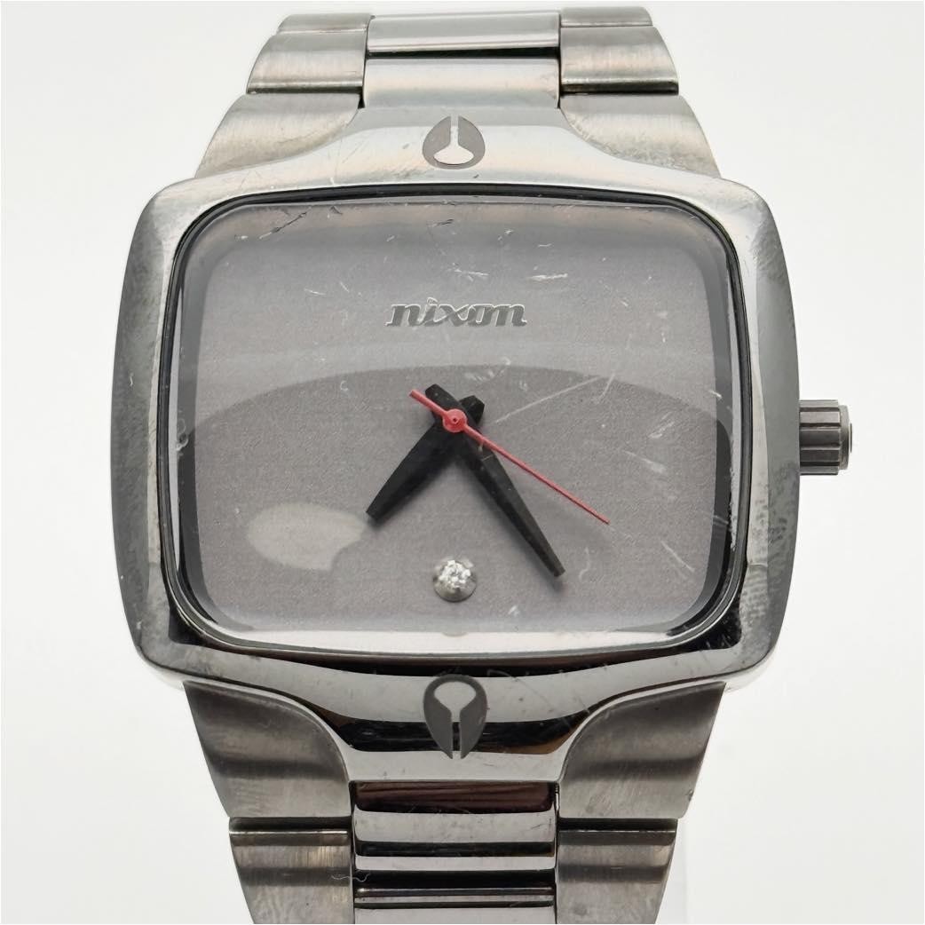 Nixon The Player Quartz Stainless Steel Square Case Silver Dial Men In hand