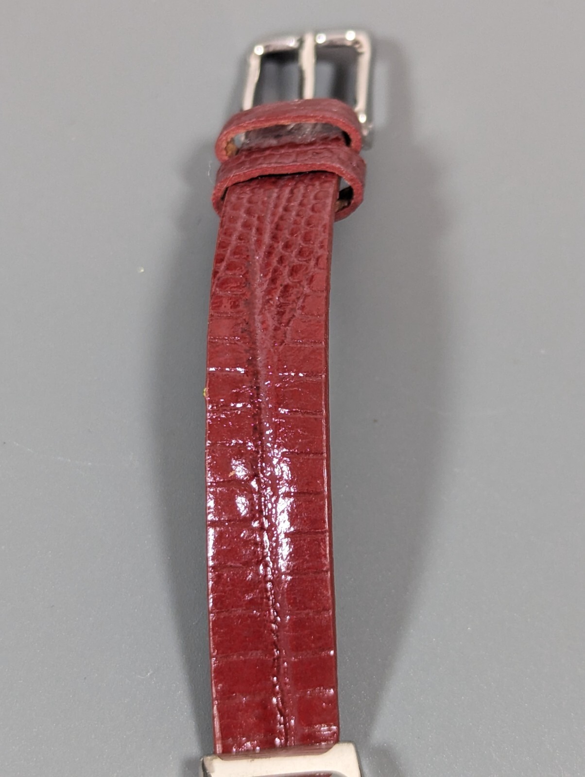 Black Dial Silver Tone Oval Case Red Leather Band Watch