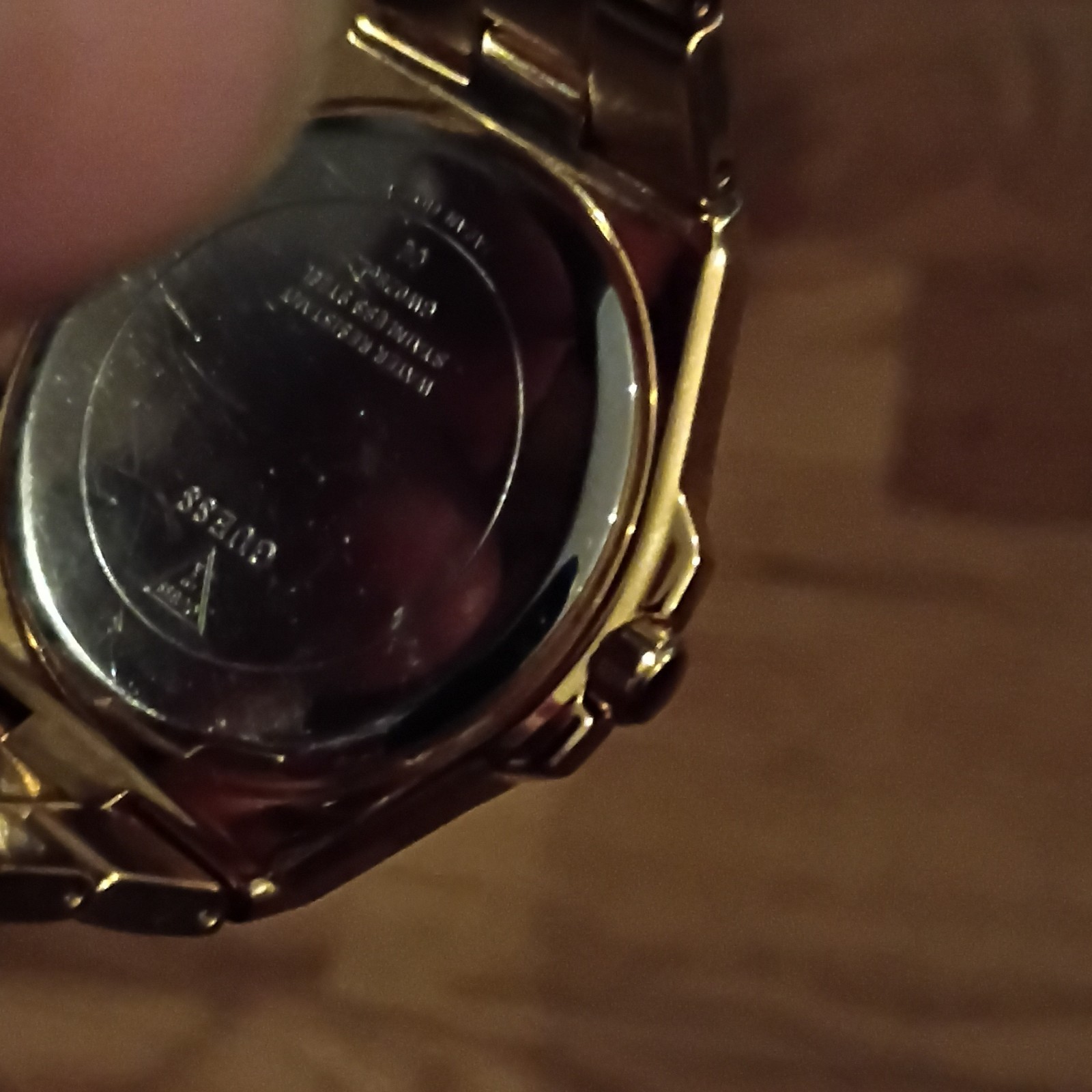 GUESS Women’s Gold Tone Analog Dress Watch White Dial Roman/Gem Bezel Date